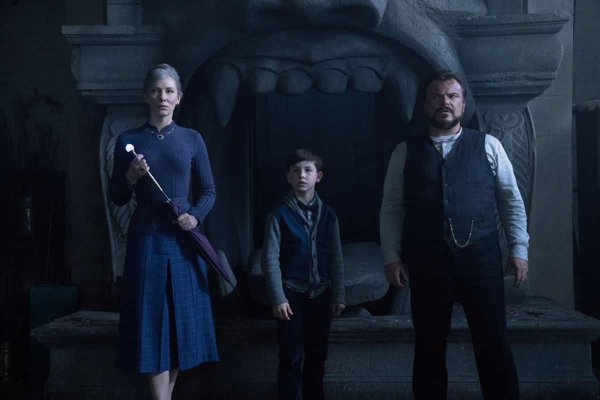 cate blanchett and jack black flank a small child in a spooky house