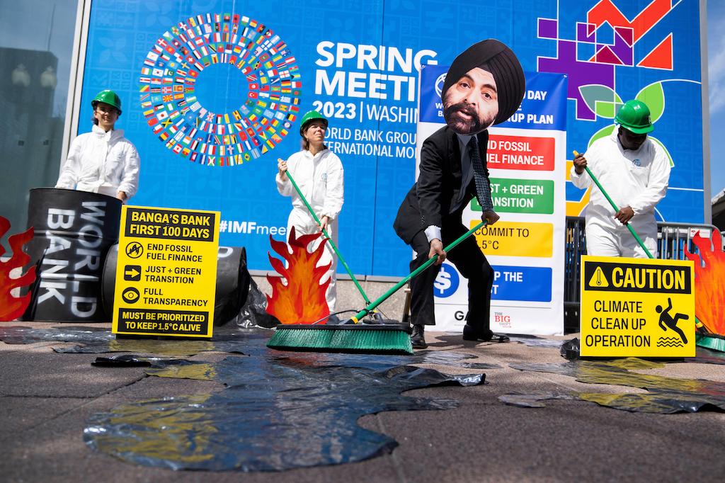  An activist portraying incoming World Bank president Ajay Banga pretends to clean up oil at 19th Street and Pennsylvania Avenue, NW, during the World Bank Group and IMF spring meetings on 11 April 2023. 
