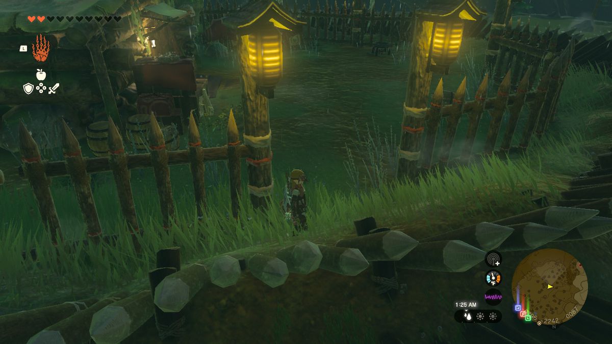 Link stands next to the entrances of the Yiga hideout in Zelda: Tears of the Kingdom