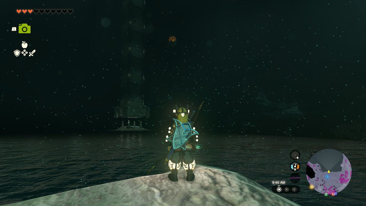 Link stands before a large lake with a monolith in its center in Zelda: Tears of the Kingdom