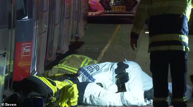 NSW Police officers and firefighters worked frantically to free the girl trapped under tram carriages, who tragically died at the scene