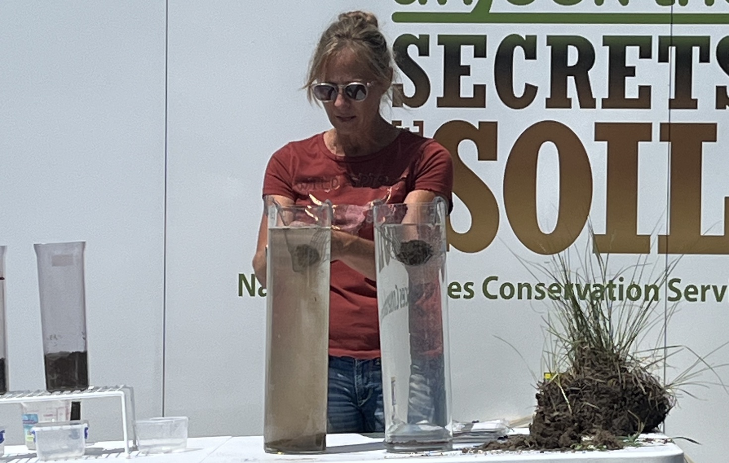 A person shows off a soil experiment