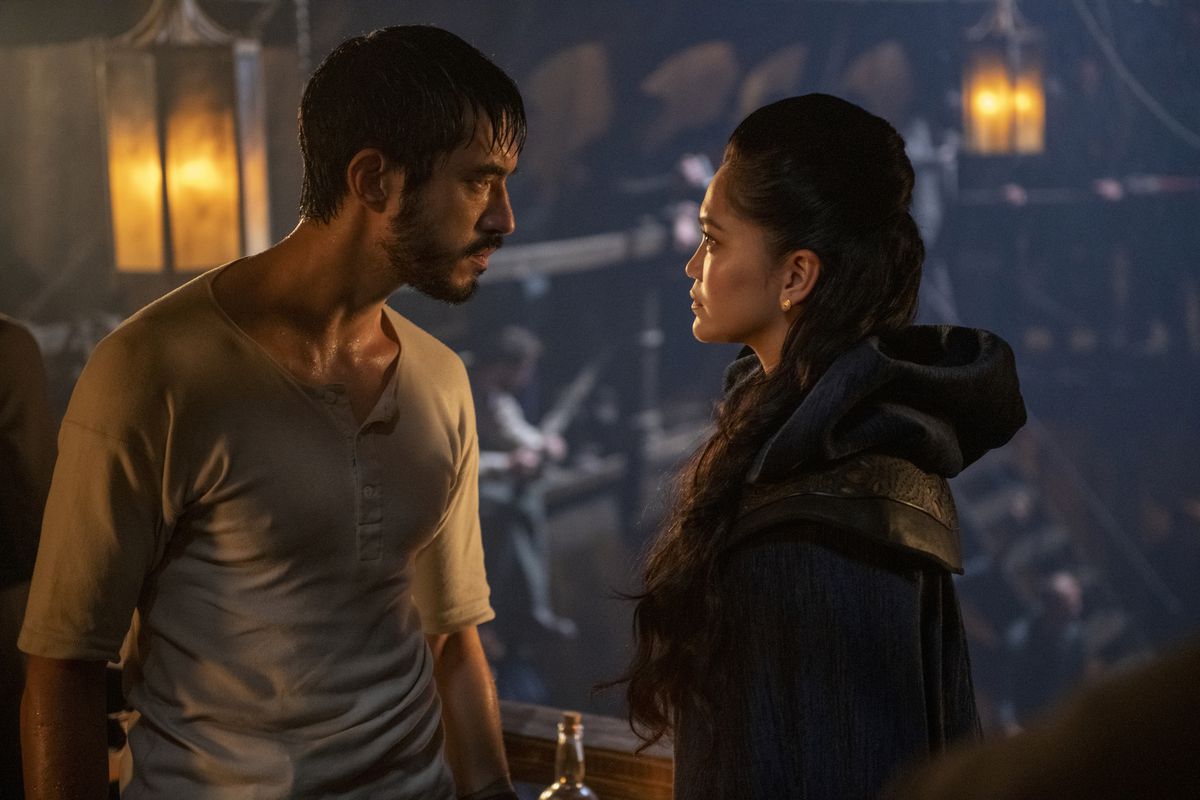 Andrew Koji, drenched in sweat and wearing a white top, shares a heated glance with his sister (portrayed by Dianne Doan) in Warrior.