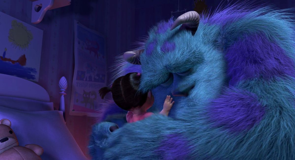fluffy blue monster Sully embraces small child Boo