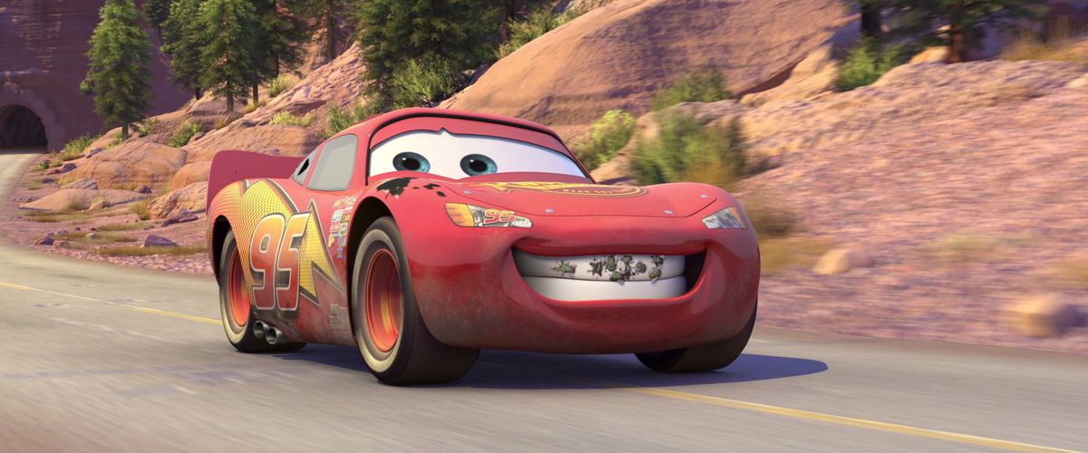 a red racecar flashes a bug-splattered grin