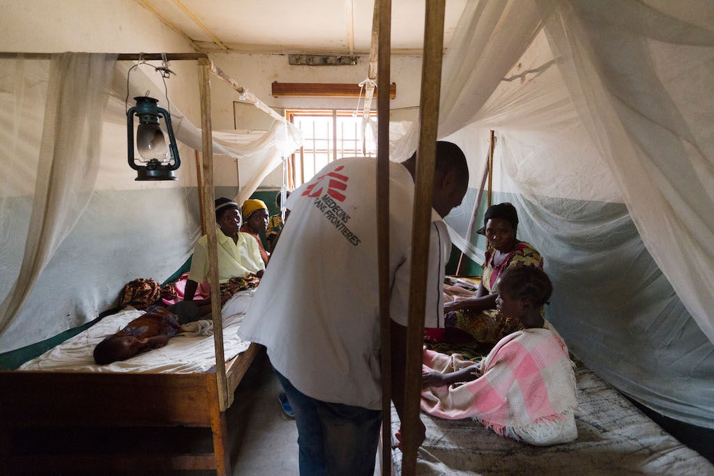 A Médecins Sans Frontières official attends to patients at the Kinyandonyi health center in the Democratic Republic of Congo.