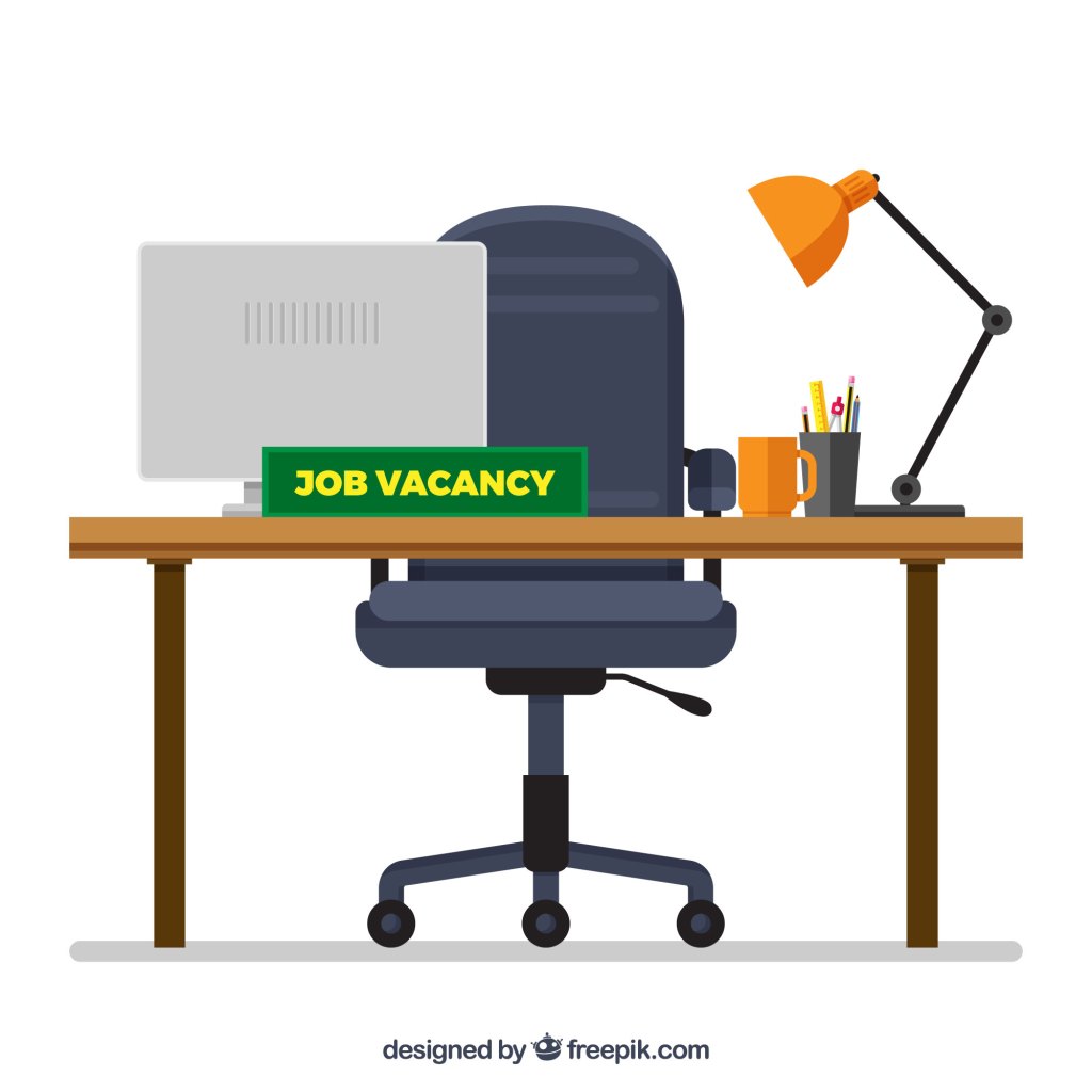 Image of a work desk with a board saying "Job Vacancy"