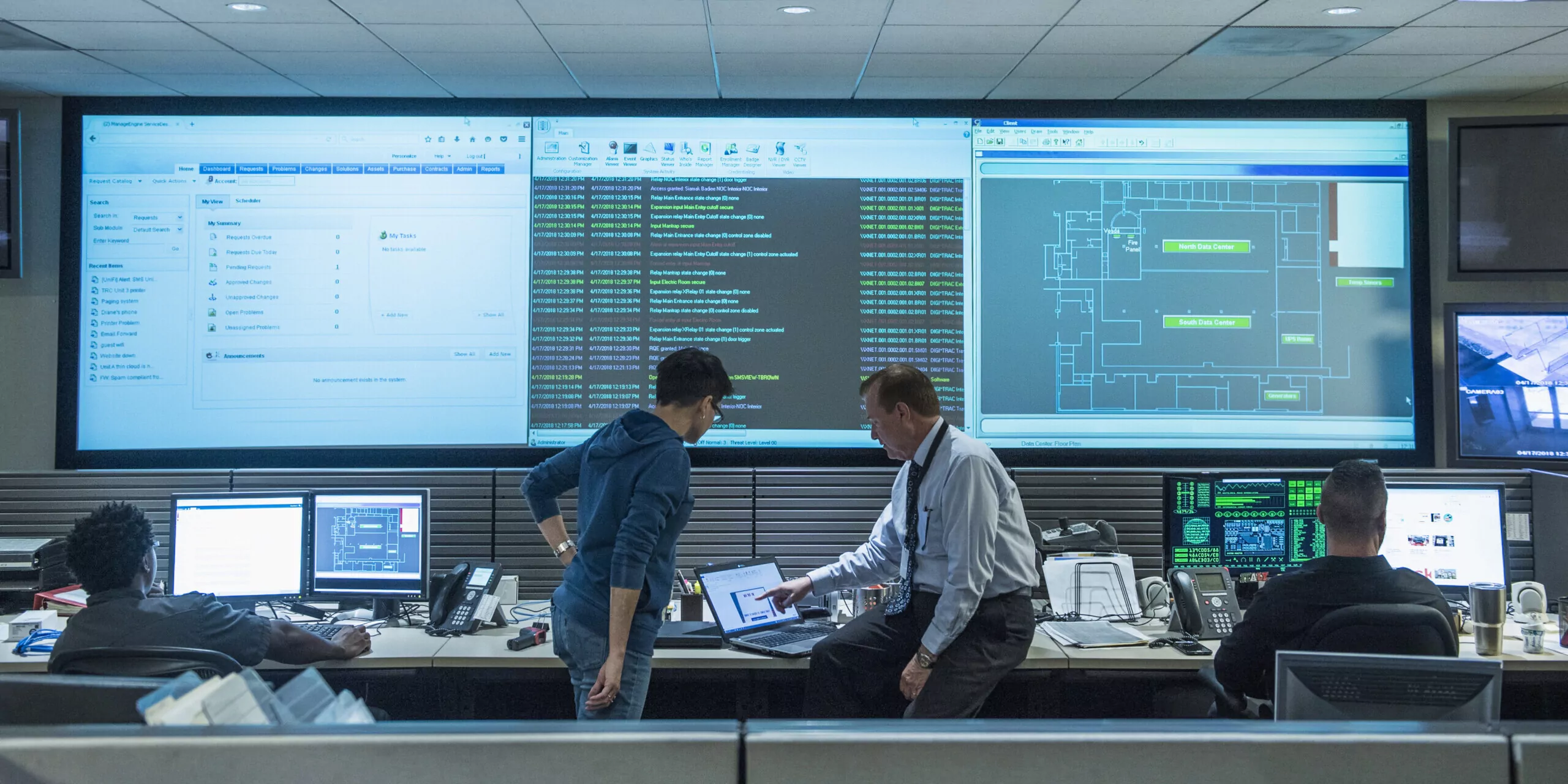 Colleagues working together in server control room for data security and data governance