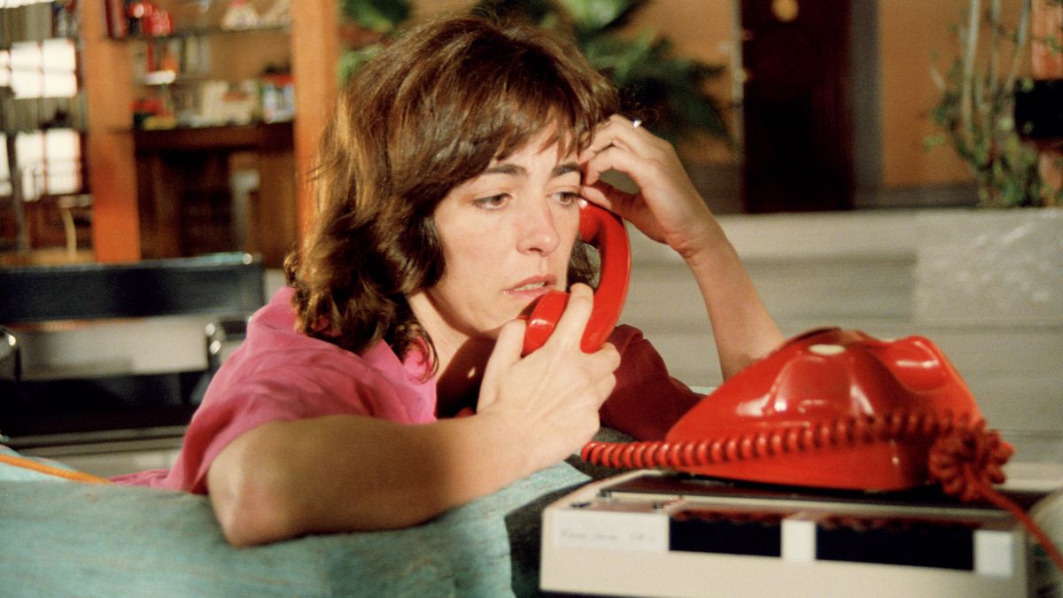Carmen Maura speaking into a red corded telephone, looking visibly distraught in Women on the Verge of a Nervous Breakdown.