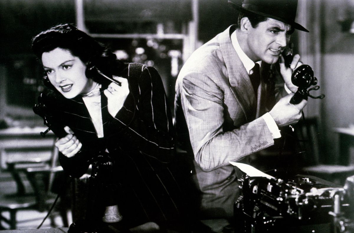 (L-R) Rosalind Russell and Cary Grant talking on seperate phones beside one another in His Girl Friday.