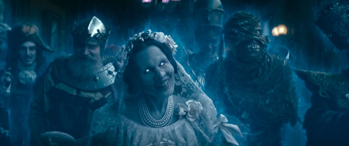 A group of ghosts in Haunted Mansion, led by a snarling bride in white.