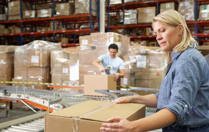 Benefits of a Warehouse Management System - Workers Working in a Packing Area.