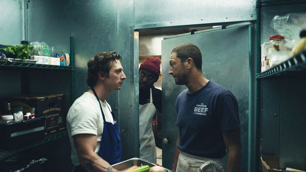 Carmy (Jeremy Allen White) standing in a walk-in fridge talking to Richie (Ebon Moss-Bachrach) while Marcus (Lionel Boyce) pokes his head in the door.