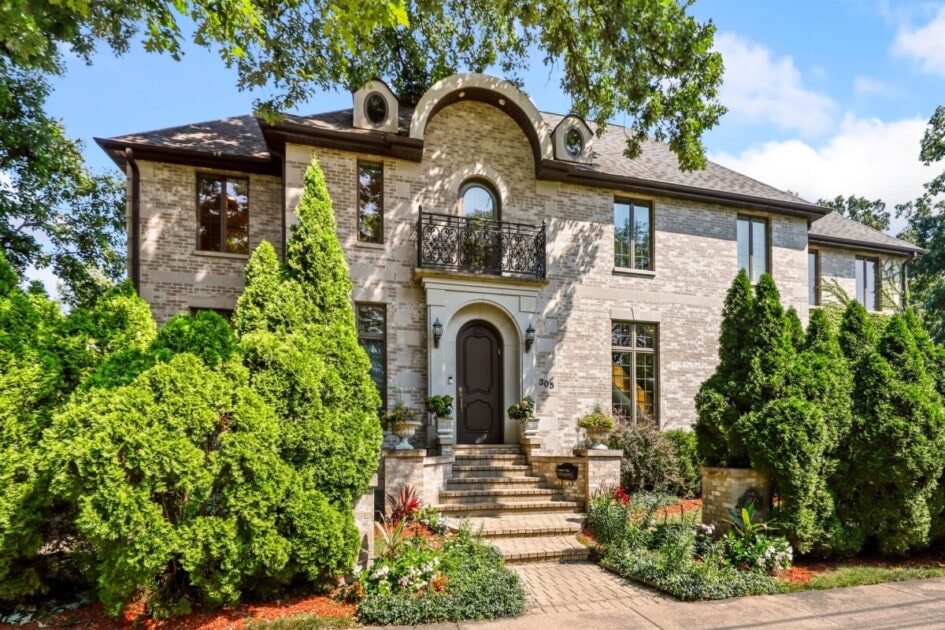 Two story brick mansion with mature landscaping