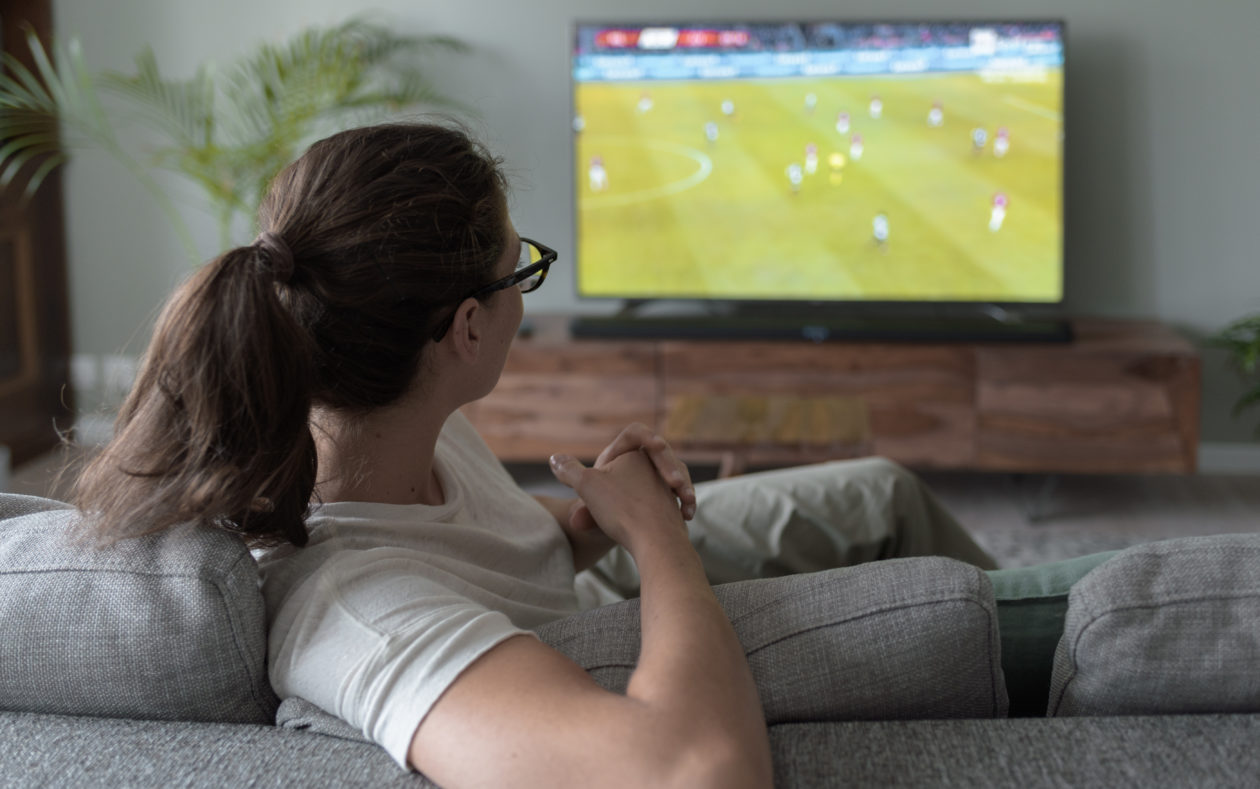 Woman watching football on TV
