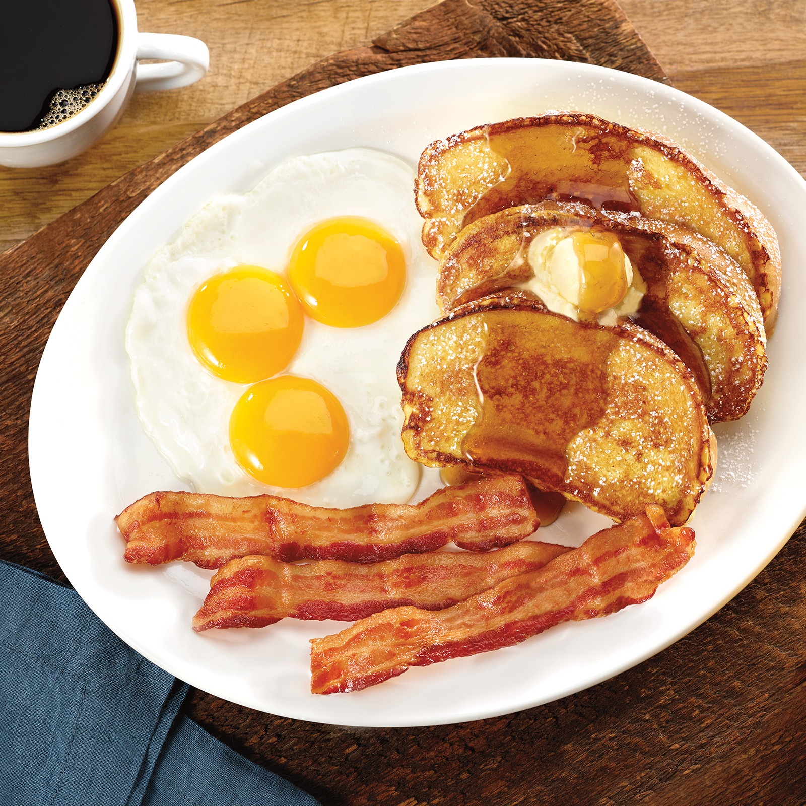 eggs, bacon, and toast with butter and syrup at the Village Inn menu