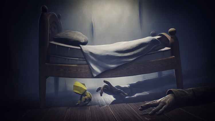 Litte Nightmares mängija voodi all, ei vaata käsi, mis ulatuvad
