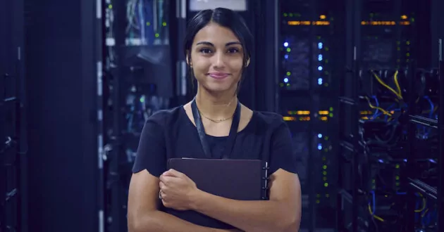 Portrait of smiling female technician in server room