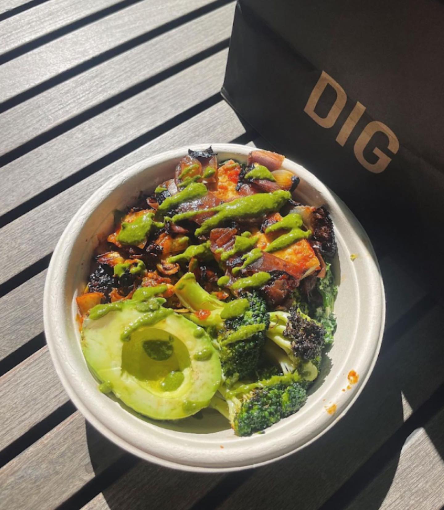 avocado and broccoli salad bowl next to a DIG bag at a DIG fundraiser 