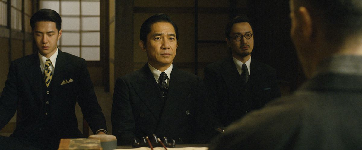 (L-R) Wang Yibo, Tony Leung, Chengpeng Dong sitting across a table from an unseen man in Hidden Blade.