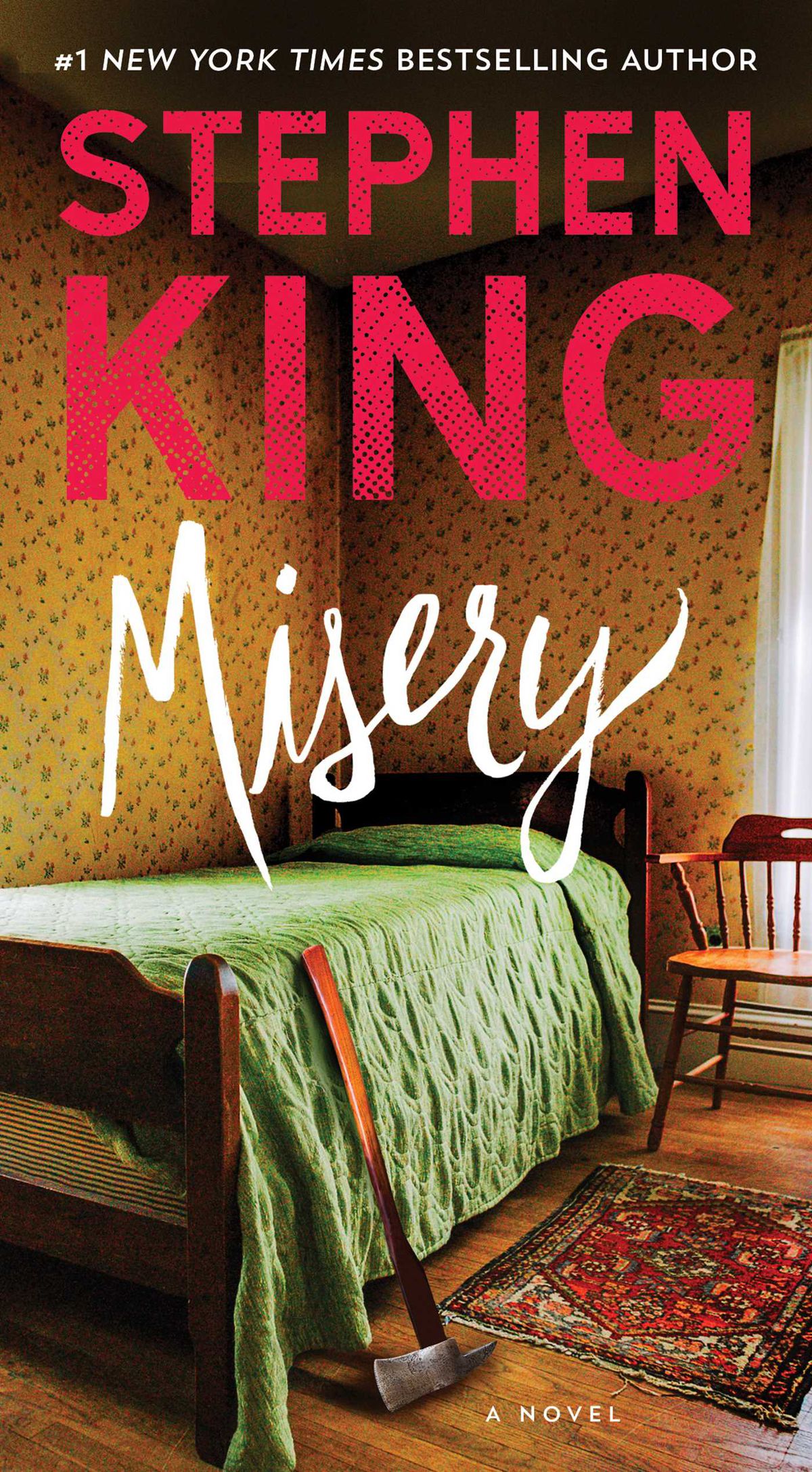 A cover of Stephen King’s Misery, showing a quaint cottage bedroom with yellow wallpaper with a flower pattern, a wooden chair, a single wooden bed with a green coverlet, and an axe leaning up against the foot of the bed