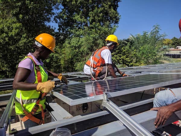 People installing solar on a roof