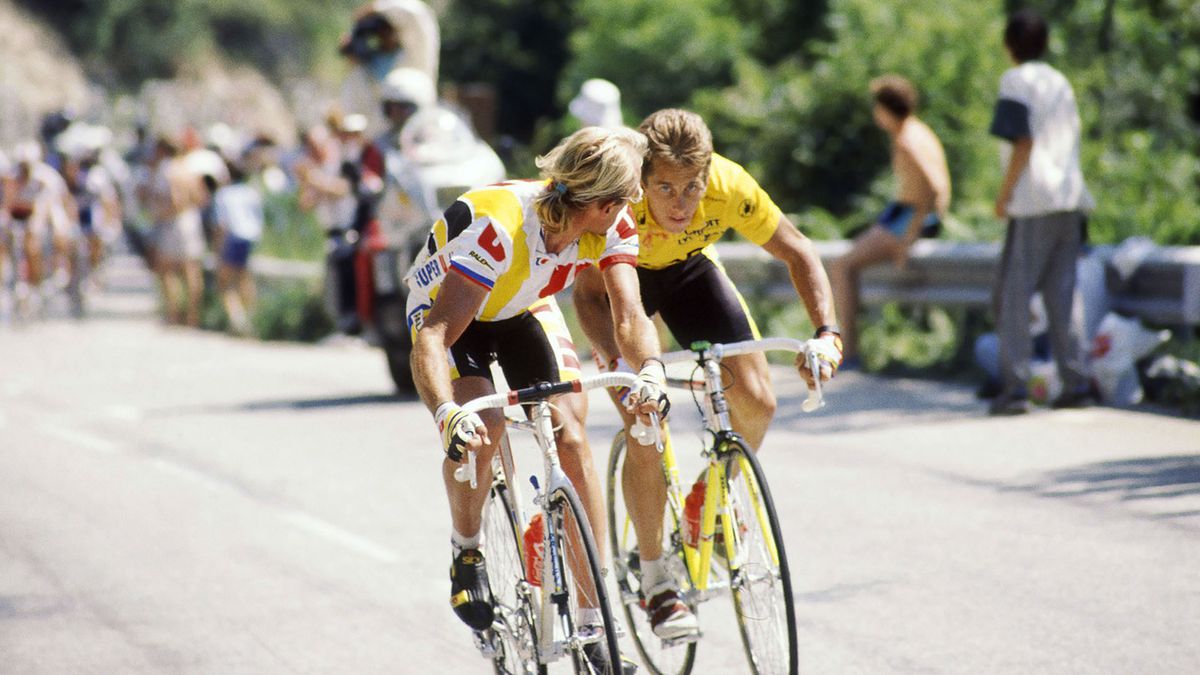 Greg LeMond riding alongside another cyclist during the Tour de France in The Last Rider.