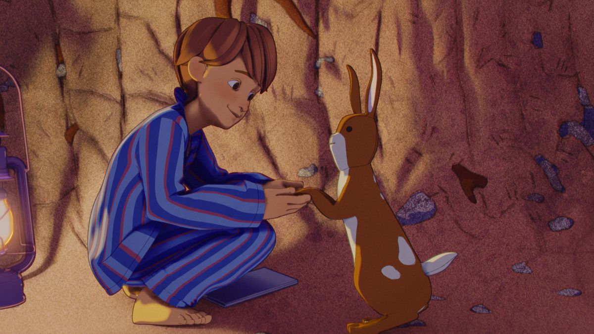 (L-R) William (voiced by Phoenix Laroche) and Velveteen Rabbit (voiced by Alex Lawther) in The Velveteen Rabbit.