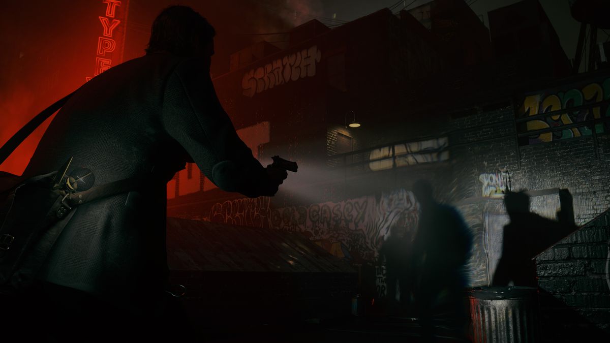 Alan Wake points a flashlight and pistol at a group of shadowy figures on a rooftop in Alan Wake 2.