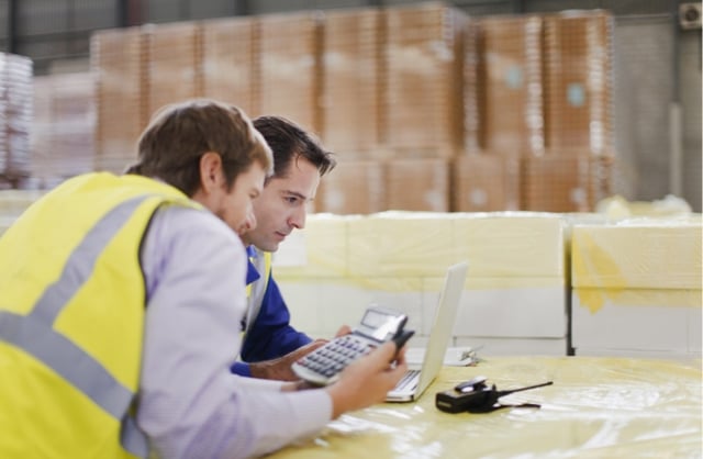 Warehouse manager calculating WMS software cost