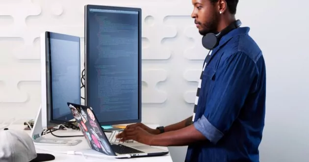 A software developer at a standing desk