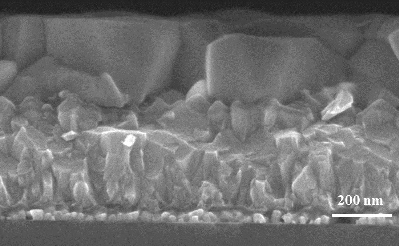 Under the scanning electron microscope, the CsPbI3 layer (large blocks in the upper part of the image) on the FTO substrate looks almost exactly the same after annealing in ambient air as after annealing under controlled conditions