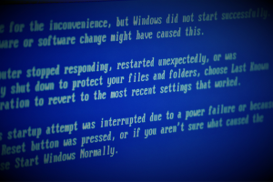 Section of a computer screen with an incompletely legible system warning that the computer has stopped responding and requires a restart, etc.