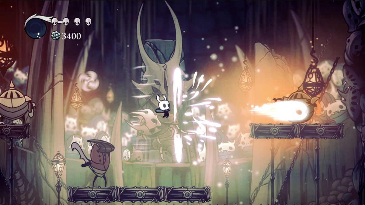 The player character firing a projectile at an enemy on a platform in an arena boss battle in Hollow Knight.
