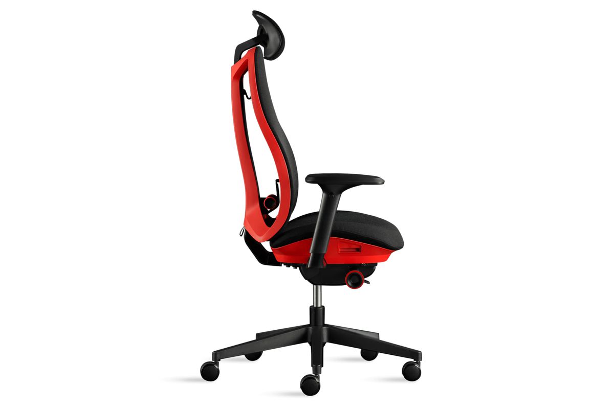 This image shows the black and red Herman Miller x Logitech Vantum G gaming chair from a side profile. In addition to showing off its seat, arm rests, head rest, and wheels, the image highlights the unique lumbar support system.