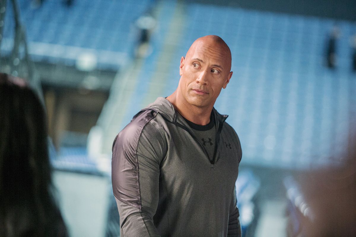 Dwayne Johnson wearing gray Under Armour gear in Fighting With My Family