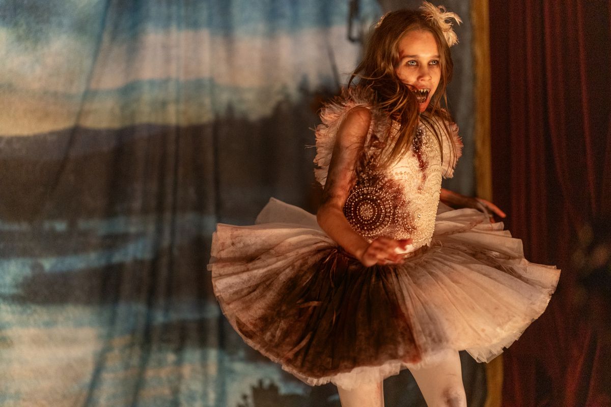 Alisha Weir in a blood-stained tutu with sharpened teeth in Abigail