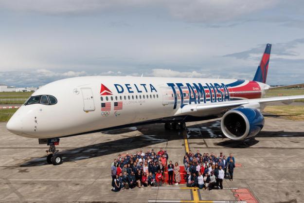 Delta's Chairman's Club Honorees pose with Delta's custom Airbus A350 Team USA aircraft.