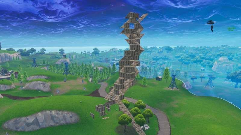 A huge player-built box tower reaches up to the sky in Fortnite.