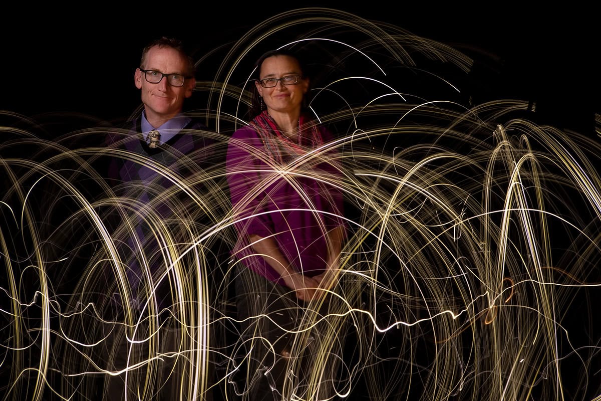 Photo of two people superimposed with artist impression of radio waves