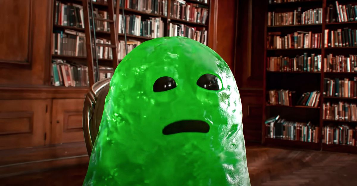 Slime, a CG imaginary friend who looks like a big, green glob with shiny black eyes and a black gouge for a mouth, sits in a library in John Krasinski’s IF