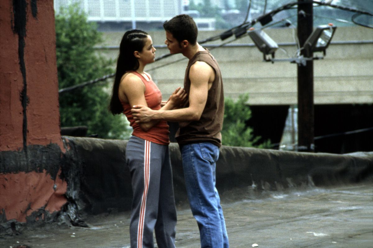 Michelle Rodriguez and Santiago Douglas embrace in a scene in Girlfight