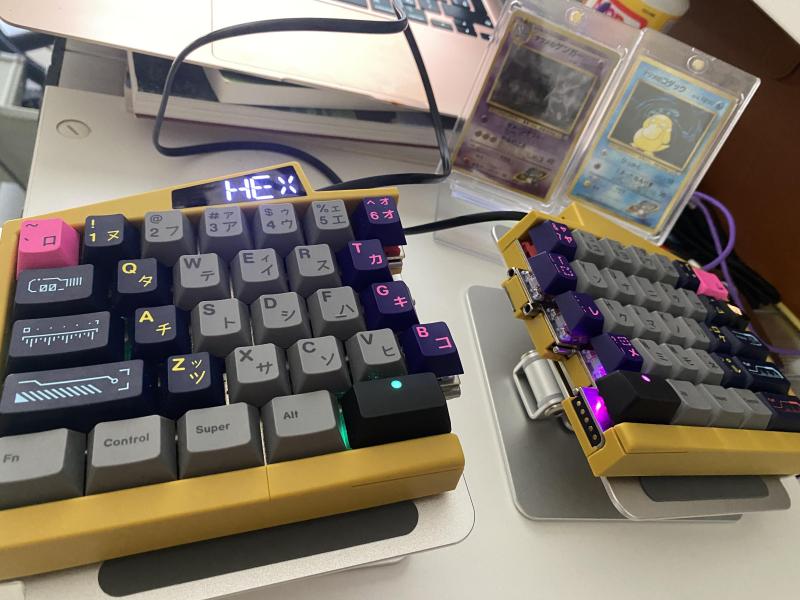 A split keyboard with keycaps from three different sets.