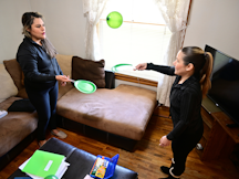 Home visitor and parent play makeshift tennis game