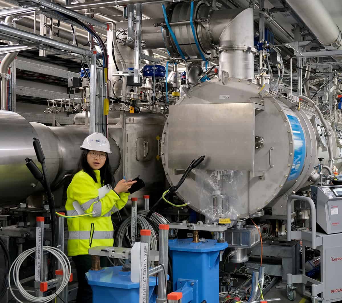 Jianqin Zhang with the beta elliptical cryomodule at the ESS superconducting linear accelerator