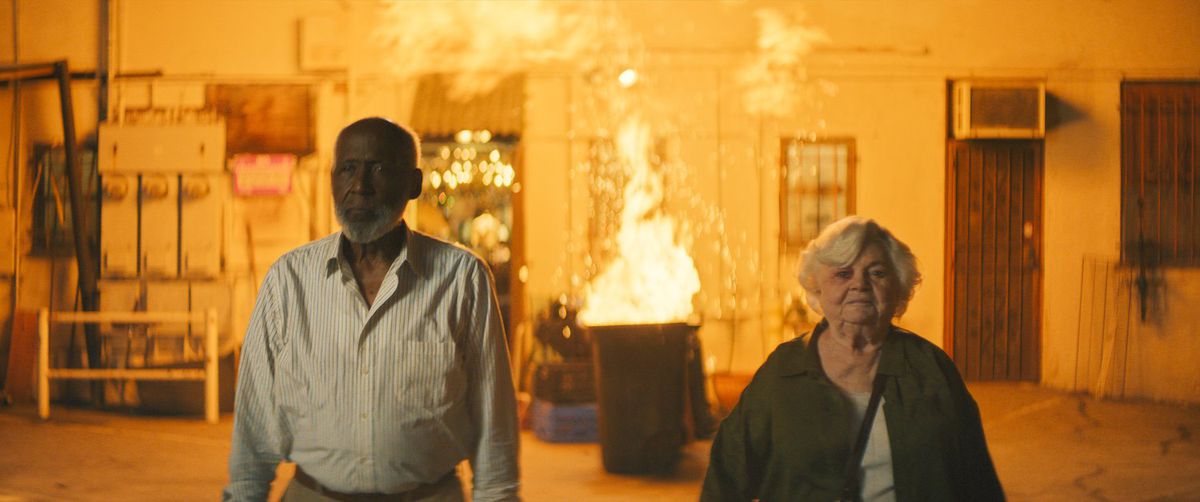 June Squibb and Richard Roundtree in Thelma, walking toward the camera away from an explosion